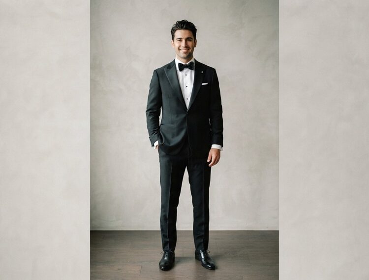 Groom wearing classic black tuxedo bow tie black tie wedding.